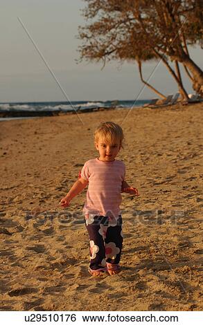 Stock Photograph - Kids playing on beach. Fotosearch