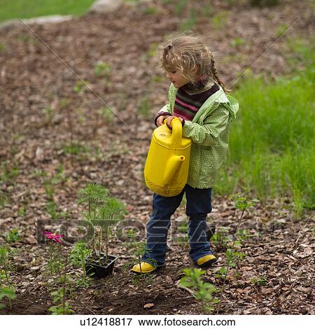 Young girl holding a watering can View Large Photo Image Stock Photo - Young girl holding a watering can. Fotosearch
