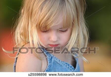 Stock Photo - Young girl looking down. Fotosearch