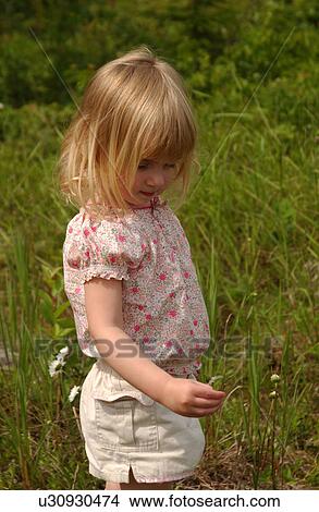 Picture - Young girl picking flowers. Fotosearch