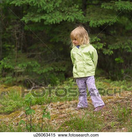 Young girl standing in the woods with her hands behind her back View Large Photo Image Stock Photography - Young girl standing in the woods with her hands behind her back. Fotosearch