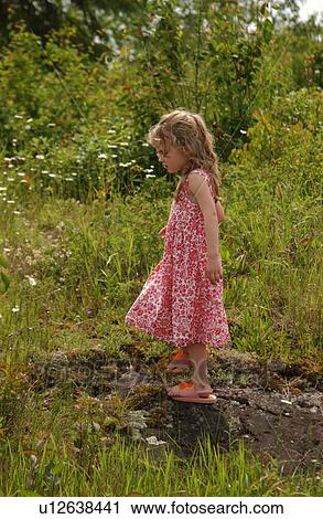 Young girl walking on a rock View Large Photo Image Stock Image - Young girl walking on a rock. Fotosearch