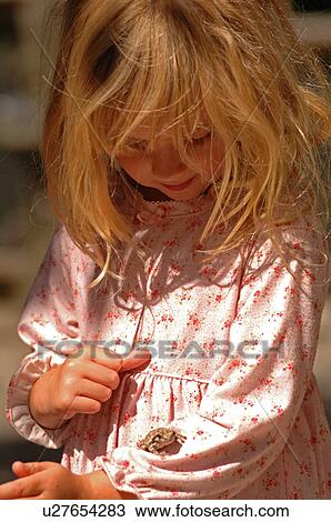 Stock Image - 6 year old holding a frog. Fotosearch