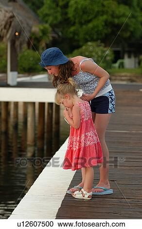A young woman with her daughter View Large Photo Image Stock Image - A young woman with her daughter. Fotosearch