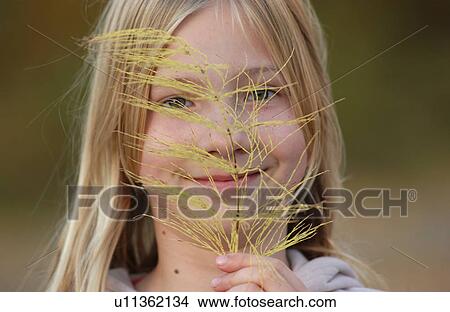 Blond Girl Holding Leaf View Large Photo Image Picture - Blond Girl Holding Leaf. Fotosearch
