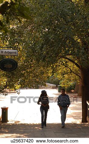 Stock Image - Couple Walking Outdoors. Fotosearch