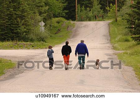 People strolling down road View Large Photo Image Stock Photo - People strolling down road. Fotosearch