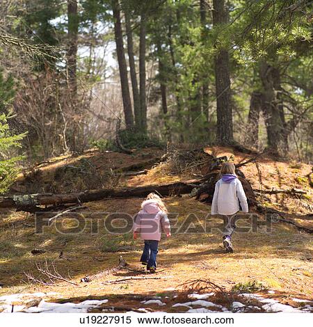 Rear view of two young girls walking View Large Photo Image Stock Photography - Rear view of two young girls walking. Fotosearch