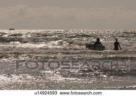 Stock Image - Surfers in Ocean. Fotosearch