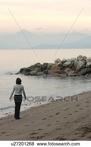 Woman Walking Along Beach View Large Photo Image Stock Photo - Woman Walking Along Beach. Fotosearch