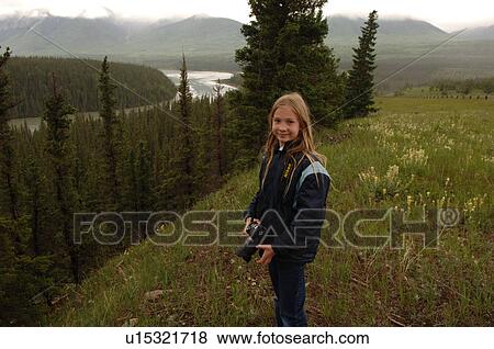 Young girl with camera overlooking landscape View Large Photo Image Stock Photo - Young girl with camera overlooking landscape. Fotosearch