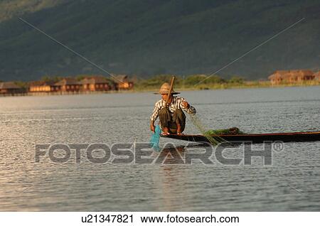 Fisherman crouching in boat View Large Photo Image Stock Image - Fisherman crouching in boat. Fotosearch