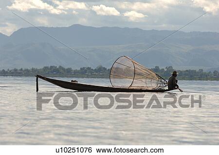 Fisherman in row boat View Large Photo Image Stock Photograph - Fisherman in row boat. Fotosearch