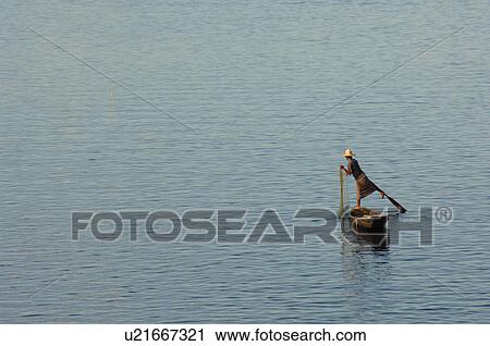 Stock Image - Fisherman leg rowing. Fotosearch