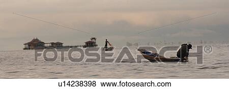 Fisherman leg rowing View Large Photo Image Stock Photo - Fisherman leg rowing. Fotosearch