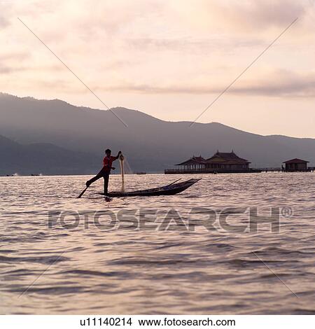 Intha fisherman in his flat-bottomed boat View Large Photo Image Picture - Intha fisherman in his flat-bottomed boat. Fotosearch