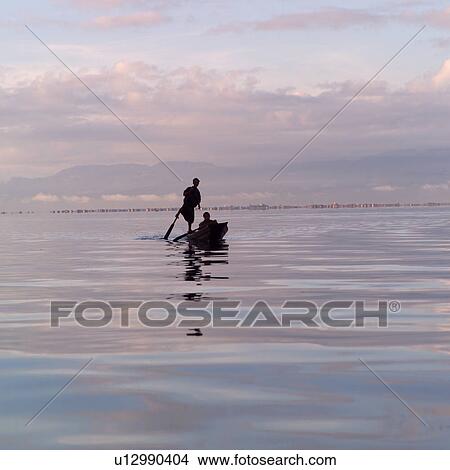 Intha fisherman in his flat-bottomed boat View Large Photo Image Picture - Intha fisherman in his flat-bottomed boat. Fotosearch