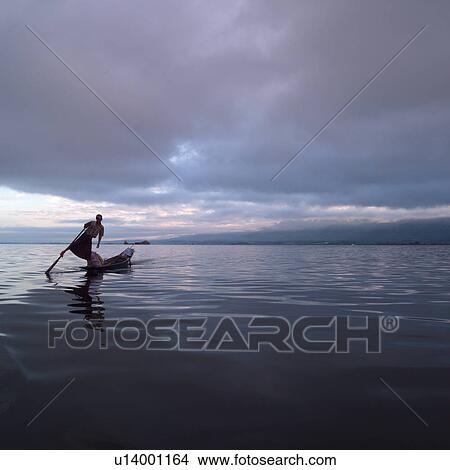 Intha fisherman in his flat-bottomed boat View Large Photo Image Picture - Intha fisherman in his flat-bottomed boat. Fotosearch
