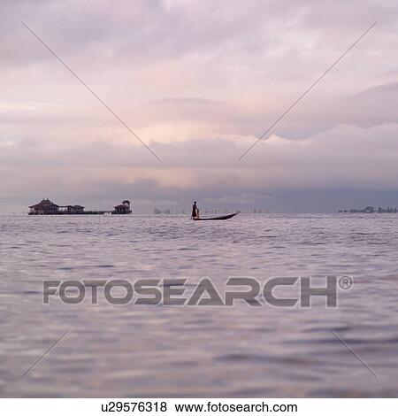 Intha fisherman in his flat-bottomed boat View Large Photo Image Stock Photo - Intha fisherman in his flat-bottomed boat. Fotosearch