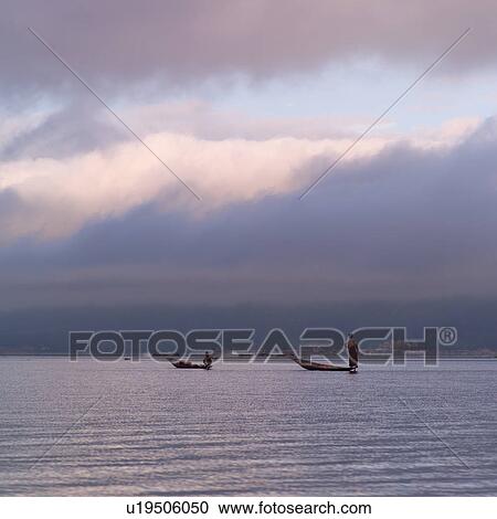 Stock Image - Intha fishermen in flat-bottomed boats. Fotosearch
