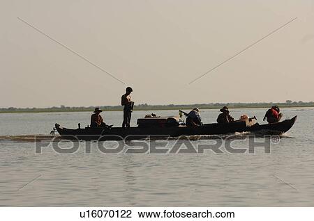 Silhouette of people on a canoe in Cambodia View Large Photo Image Stock Image - Silhouette of people on a canoe in Cambodia. Fotosearch
