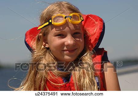 10 year old with goggles on her head View Large Photo Image Stock Image - 10 year old with goggles on her head. Fotosearch