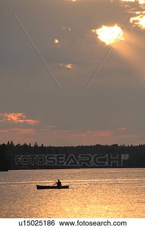 Boat on Lake of the Woods at twilight View Large Photo Image Stock Photograph - Boat on Lake of the Woods at twilight. Fotosearch
