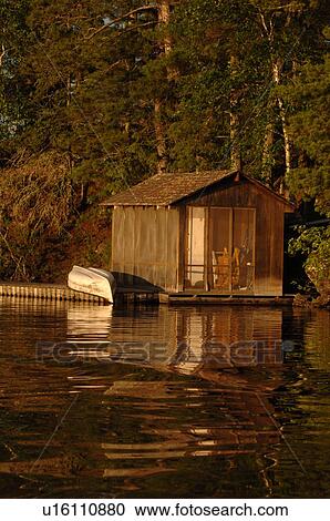 Stock Image - Canoe upside down on dock. Fotosearch