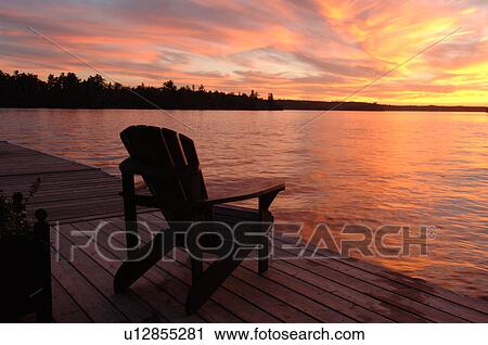 Stock Image - Empty chair against twilight sky. Fotosearch
