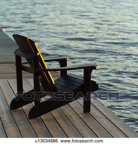 Empty chair on wooden dock View Large Photo Image Stock Photograph - Empty chair on wooden dock. Fotosearch