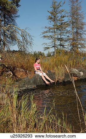Girl sitting at water's edge in bare feet View Large Photo Image Stock Image - Girl sitting at water's edge in bare feet. Fotosearch