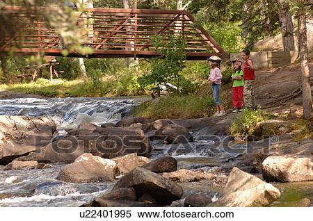 Group of children at edge of river View Large Photo Image Stock Photography - Group of children at edge of river. Fotosearch