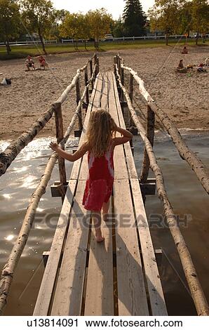 Matlock, Manitoba, 5 year old girl walking on wooden pier View Large Photo Image Stock Image - Matlock, Manitoba, 5 year old girl walking on wooden pier. Fotosearch