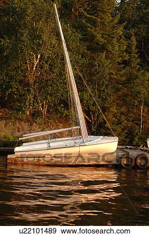 Stock Photo - Sailboat docked at Lake of the Woods. Fotosearch