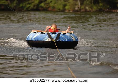Teenager floating on a raft View Large Photo Image Stock Photo - Teenager floating on a raft. Fotosearch