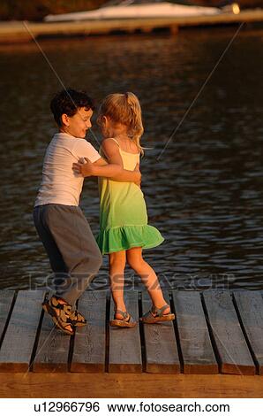 Stock Photograph - Two children dancing outdoors. Fotosearch