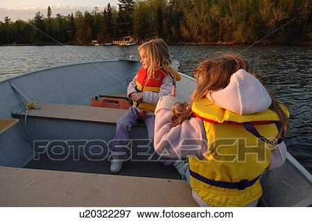 Stock Photo - Two girls sitting in a boat. Fotosearch