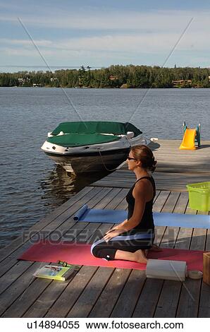 Woman doing yoga outdoors on dock View Large Photo Image Stock Photography - Woman doing yoga outdoors on dock. Fotosearch