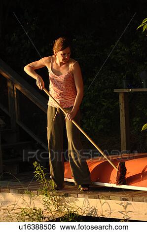 Woman scrubbing the bottom of a boat View Large Photo Image Stock Photograph - Woman scrubbing the bottom of a boat. Fotosearch