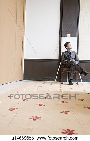 Businessman sitting on a chair and thinking View Large Photo Image Stock Photography - Businessman sitting on a chair and thinking. Fotosearch
