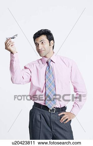 Close-up of a businessman holding a model airplane View Large Photo Image Stock Image - Close-up of a businessman holding a model airplane. Fotosearch