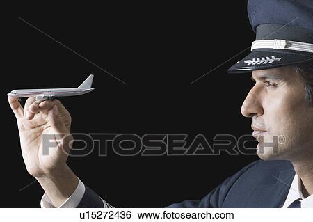Close-up of a pilot with a toy airplane on his fingers View Large Photo Image Stock Photograph - Close-up of a pilot with a toy airplane on his fingers. Fotosearch