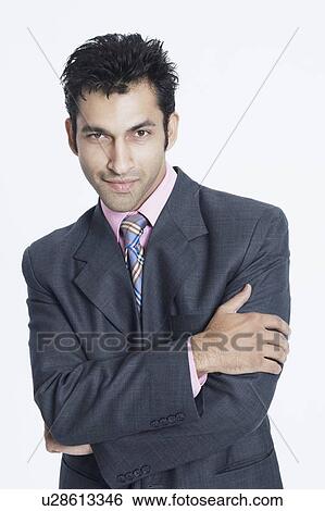 Portrait of a businessman standing with his arms crossed View Large Photo Image Stock Photograph - Portrait of a businessman standing with his arms crossed. Fotosearch