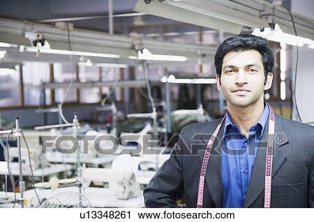 Portrait of a male fashion designer standing in a textile industry View Large Photo Image Stock Image - Portrait of a male fashion designer standing in a textile industry. Fotosearch