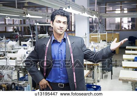 Portrait of a male fashion designer standing in a textile industry View Large Photo Image Stock Photo - Portrait of a male fashion designer standing in a textile industry. Fotosearch