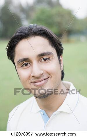 Portrait of a young man smiling View Large Photo Image Stock Photo - Portrait of a young man smiling. Fotosearch