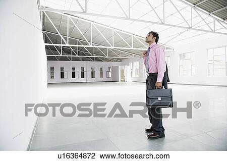Side profile of a businessman holding a briefcase View Large Photo Image Stock Image - Side profile of a businessman holding a briefcase. Fotosearch