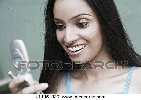 Close-up of a teenage girl holding a mobile phone View Large Photo Image Stock Photo - Close-up of a teenage girl holding a mobile phone. Fotosearch