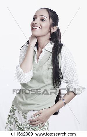 Stock Photo - Close-up of a teenage girl standing with arms akimbo. Fotosearch