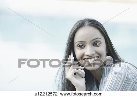 Close-up of a teenage girl talking on a mobile phone View Large Photo Image Stock Image - Close-up of a teenage girl talking on a mobile phone. Fotosearch